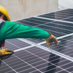Sustainable Maintenance - Solar Technician Installing Solar Panel