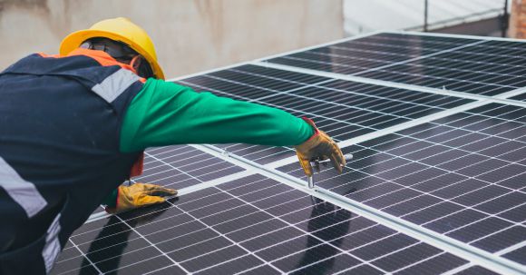 Sustainable Maintenance - Solar Technician Installing Solar Panel