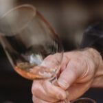 Aerate - Unrecognizable man aerating wine before tasting